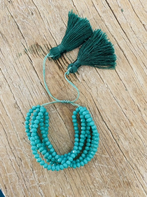 Hand-woven crystal tassel stacking bracelet.